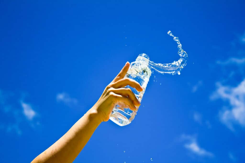 Human hand holding a bottle of water