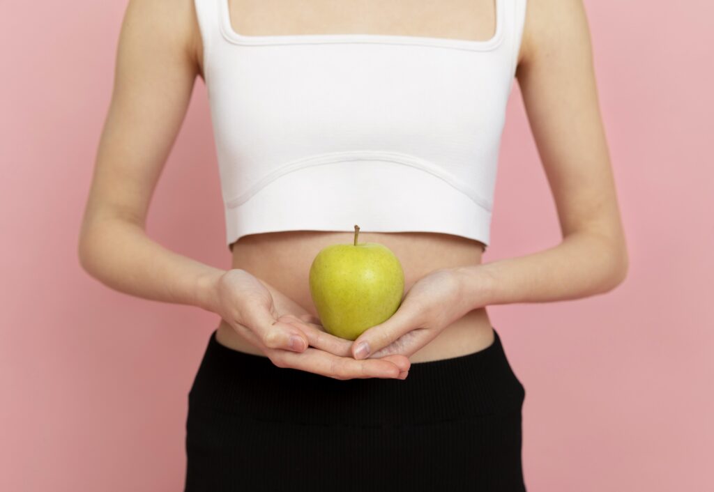 close up woman holding apple