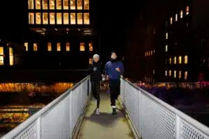 friends running bridge night city 300x200